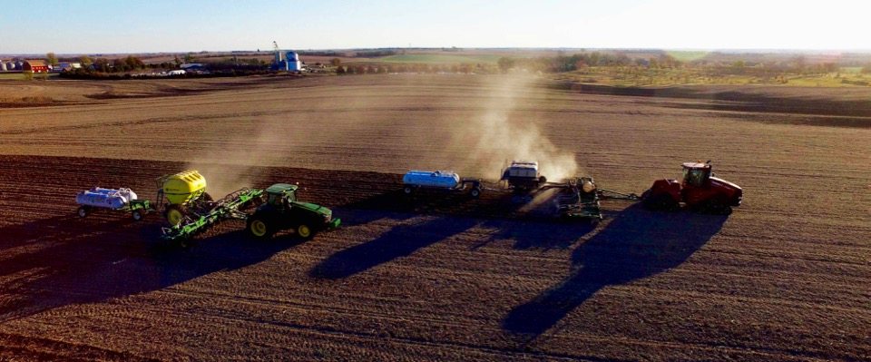 9_Ton_GEN_II_Montag_on_Tracks_behind_16_row_JD2510S_Strip_Till_bar_and_9_Ton_JD2510H_with_Dry_Fertilizer_running_side_by_side