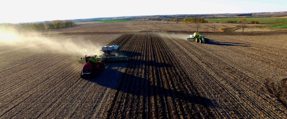 9_Ton_GEN_II_Montag_on_Tracks_behind_16_row_JD_2510S_Strip_Till_bar_and_9_Ton_JD_2510H_with_Dry_Fertilizer_running_side_by_side